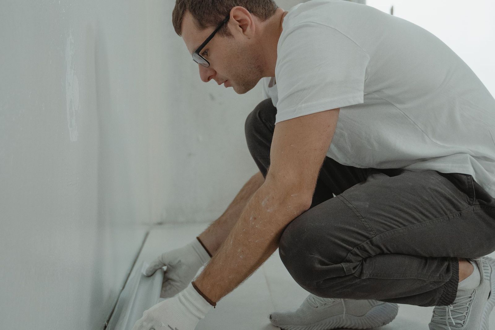 Craftsperson fitting finish trim in a bright, modern interior