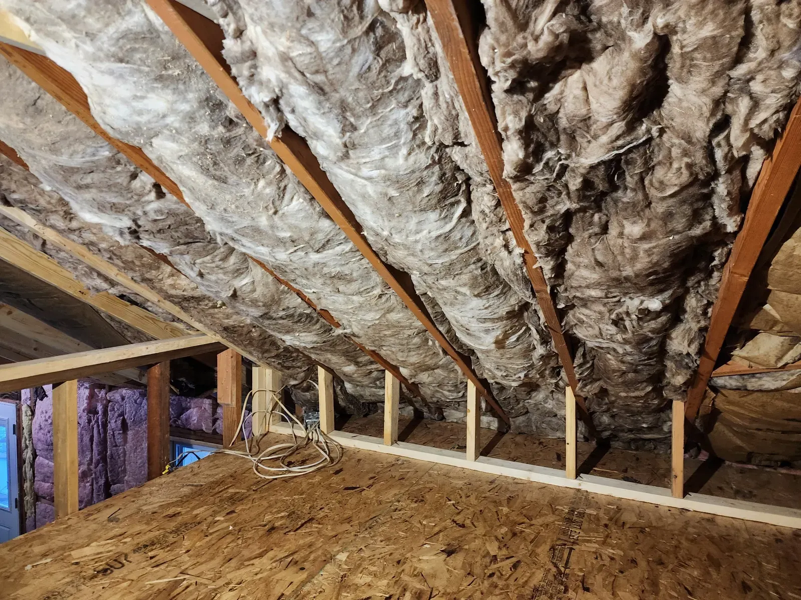 Insulation installed between the roof rafters above the cabin kitchen