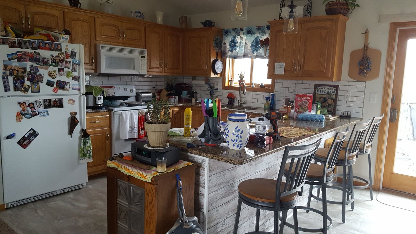 Kitchen island after installation of gray wood-look tongue-and-groove cladding