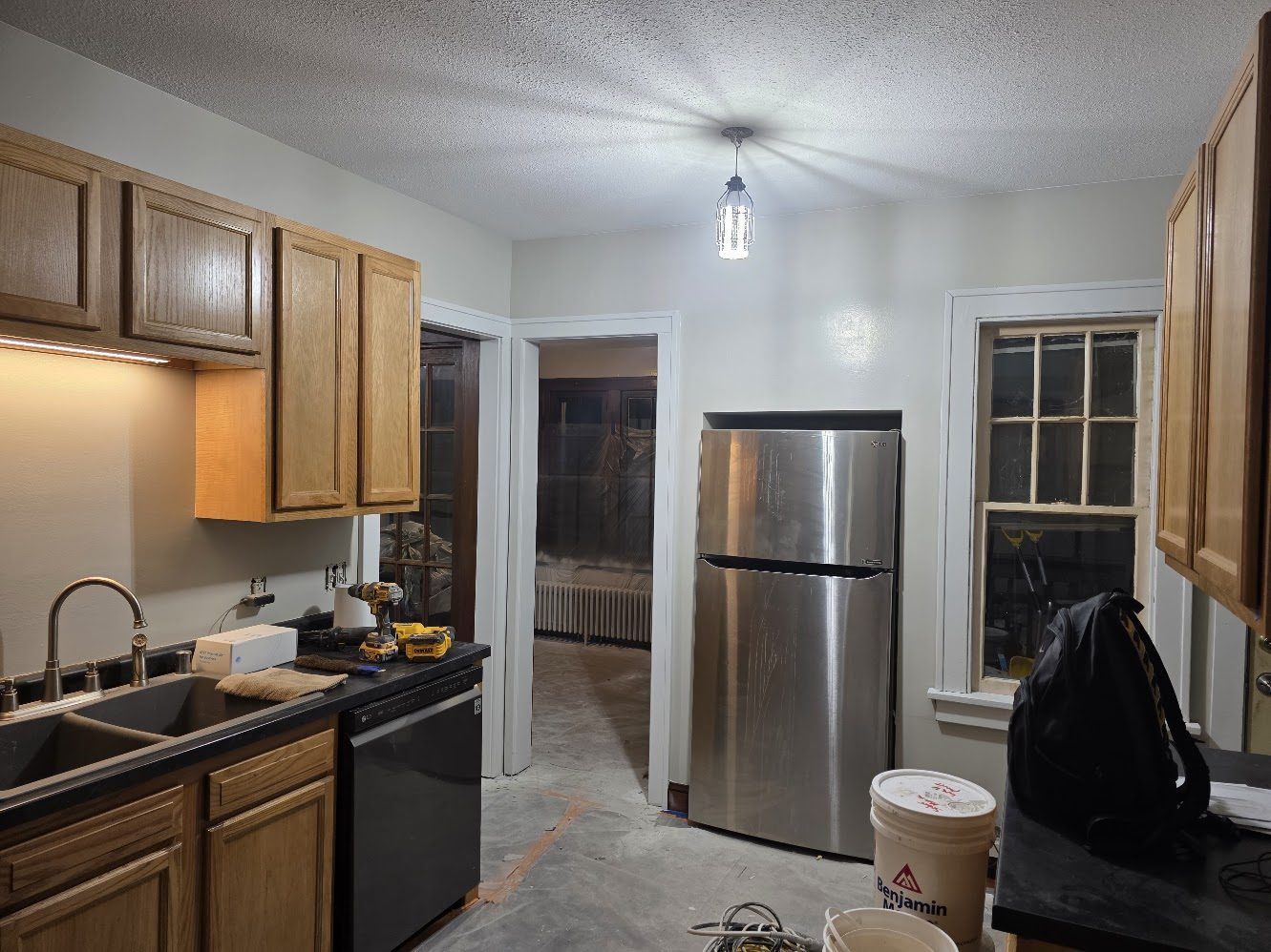 Kitchen receiving its finishing touches, with the floors still protected for work