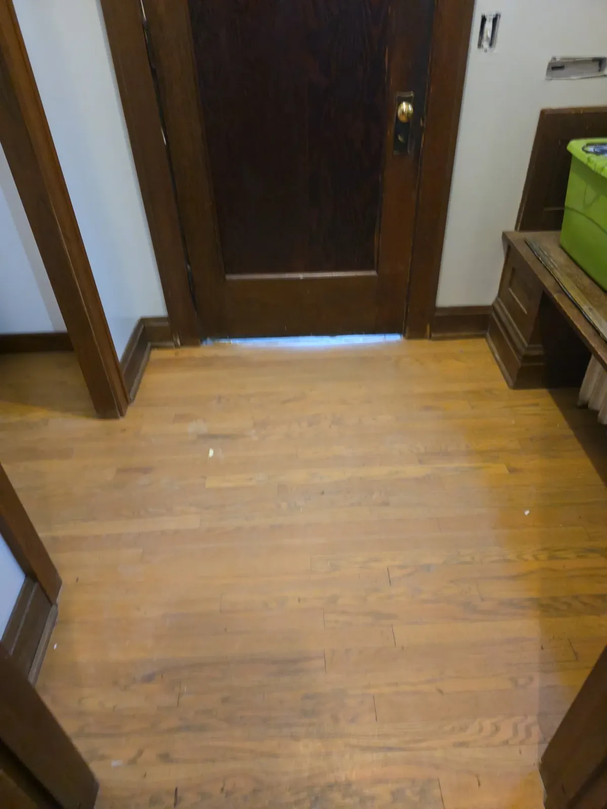 Entryway hardwood floor before refinishing