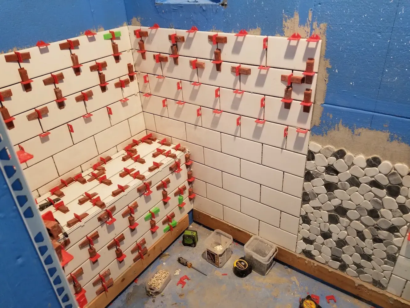 Walk-in shower floor tile being installed
