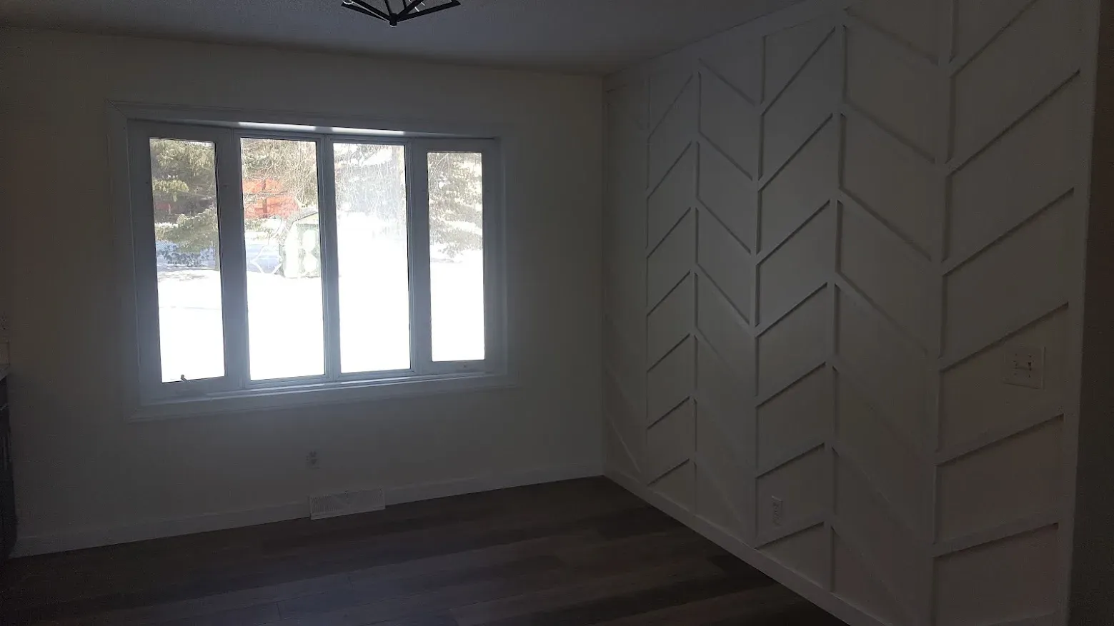 Chevron accent wall beside freshly painted windows
