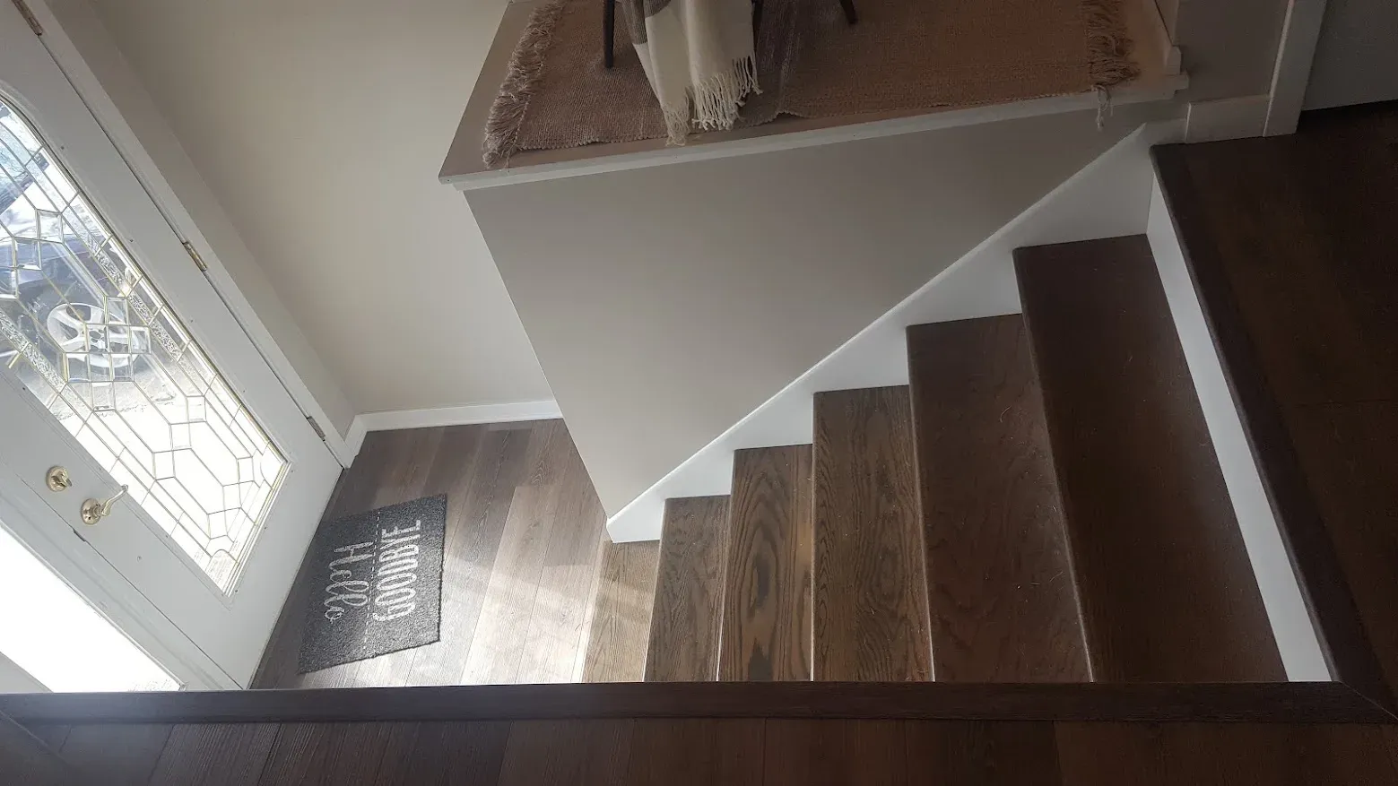 Refinished staircase with painted railing and fresh wall finishes