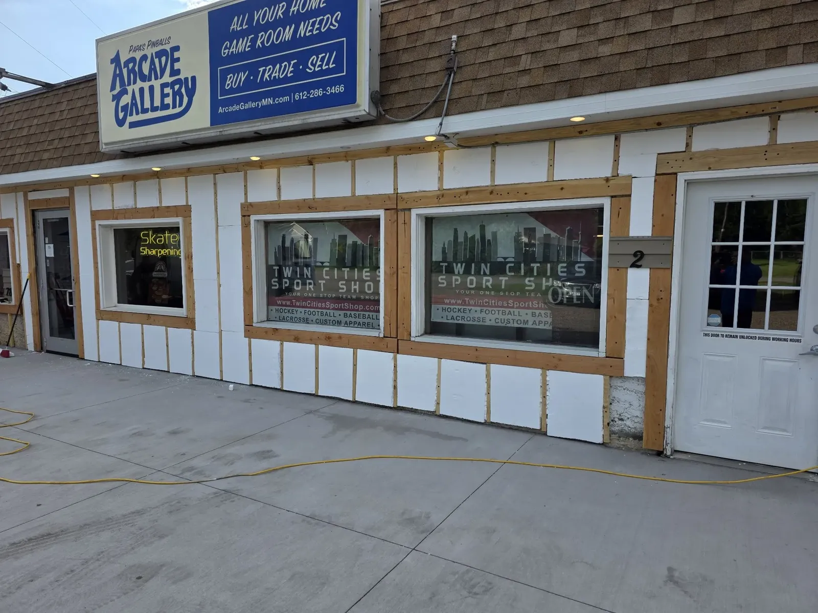 Arcade Gallery storefront opened up with insulation and framing exposed during the re-siding