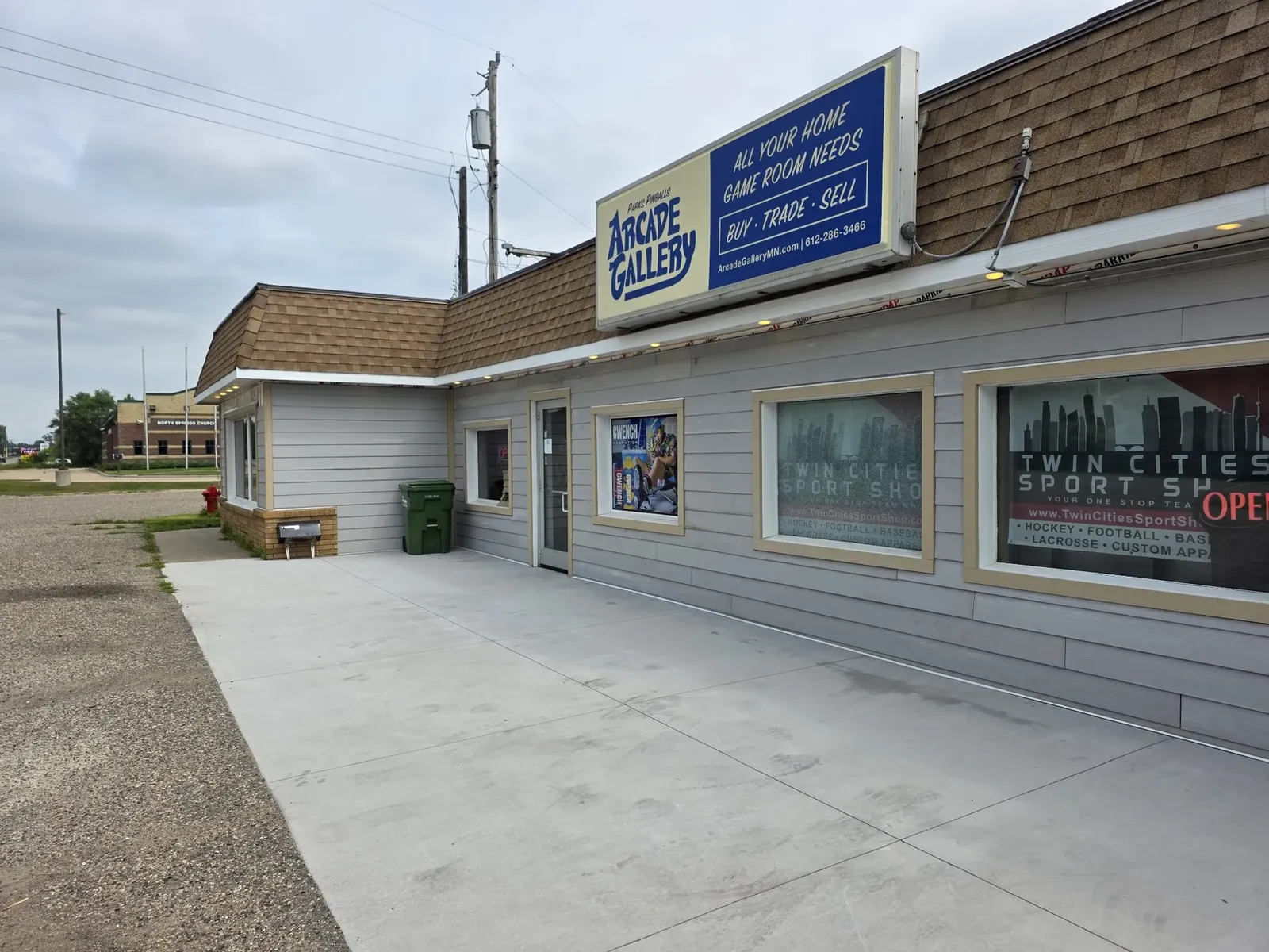 New siding installed across the performance center storefront, before paint