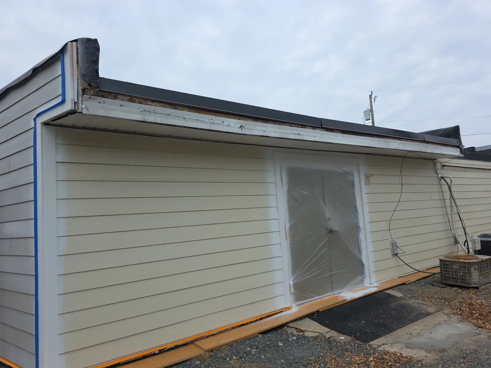 New rear siding masked off and prepped for paint during the exterior renovation