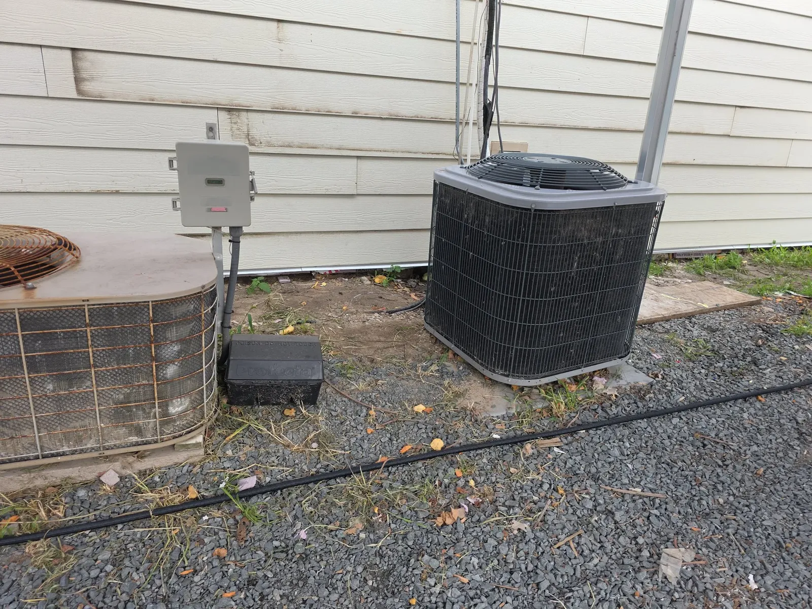 Weathered old siding behind the condensers, before the re-siding