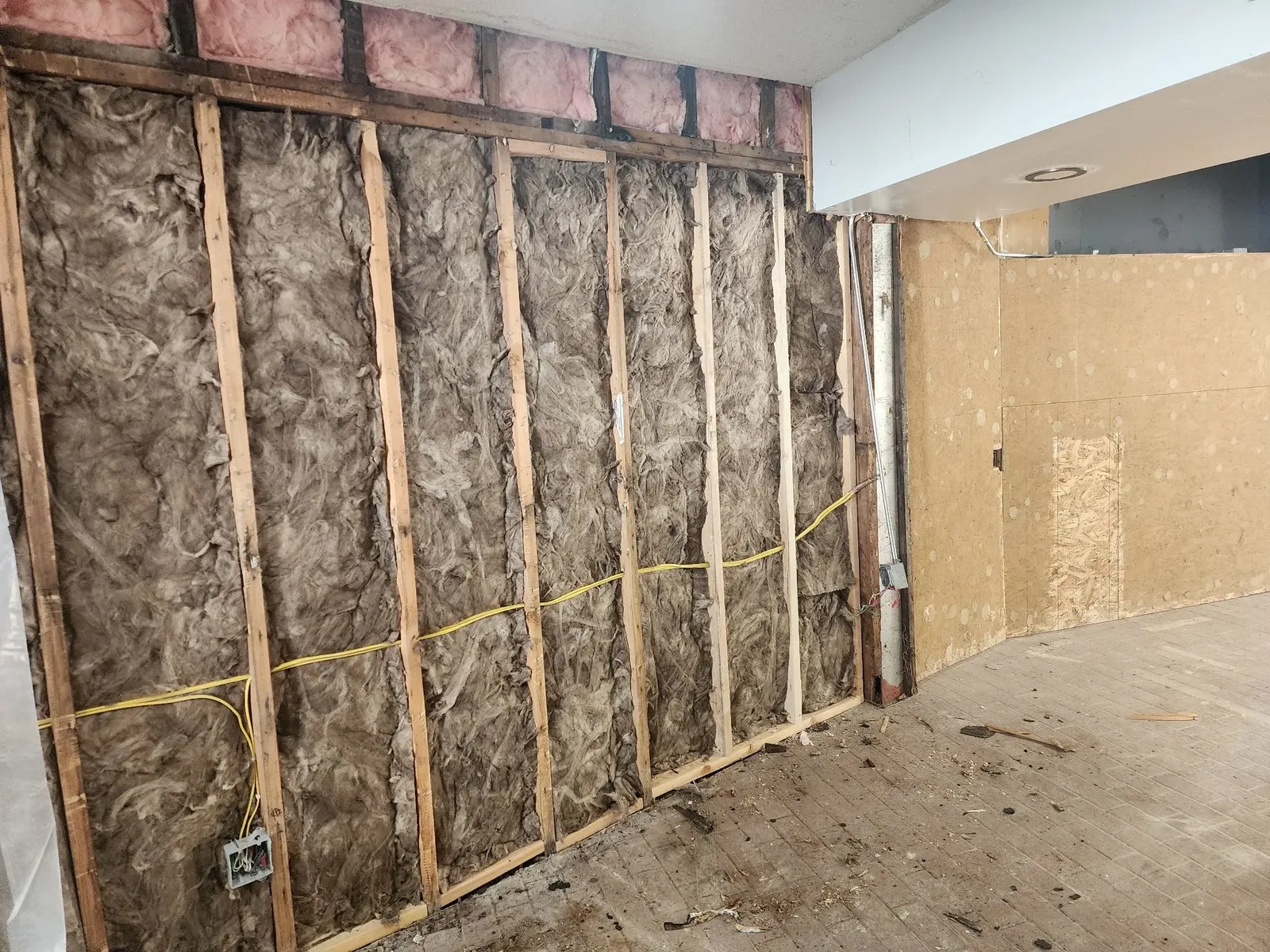 Original insulation and wiring before the commercial gym remodel