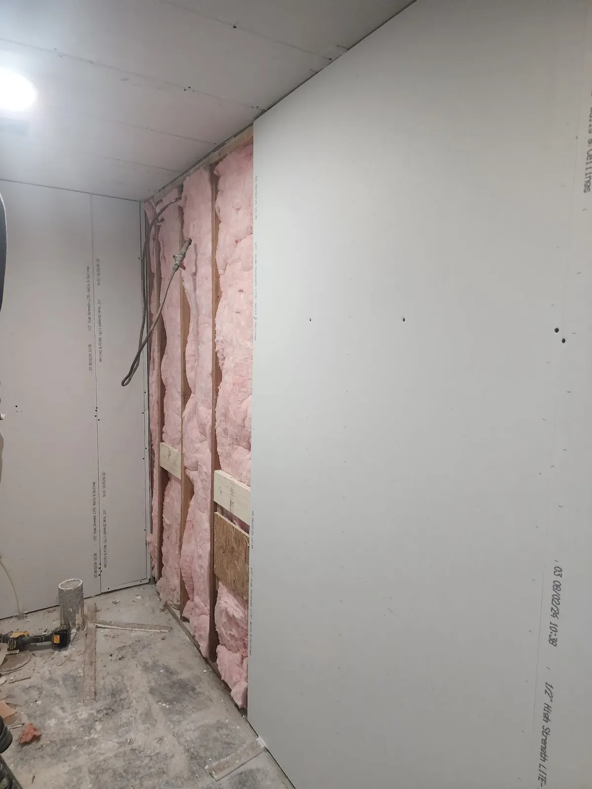 Insulation and drywall installation during the commercial gym remodel