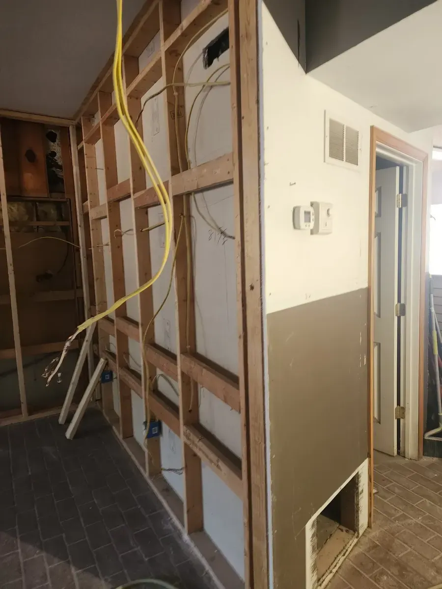 Electrical wiring run through open wall framing before drywall